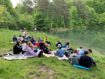 Uczniowie i wychowawca klasy 6c nad brzegiem rzeki